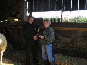 John Smithson receiving the sheep judging prize from Sue Wilkinson